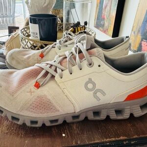 On Running White and Orange Shoes with Red Highlights